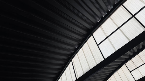 Modern industrial ceiling with corrugated metal and windows