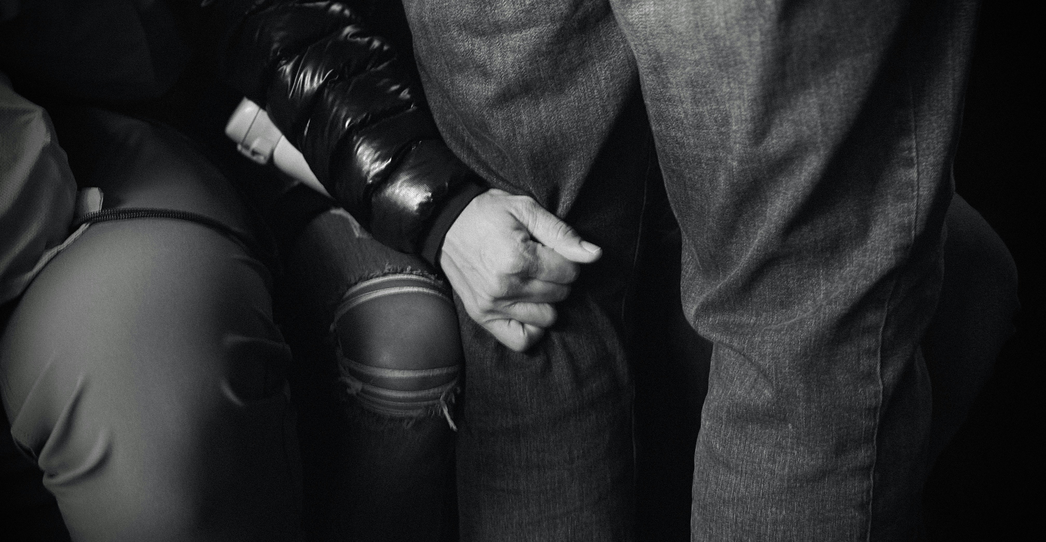 Close-up of hands holding each other tightly