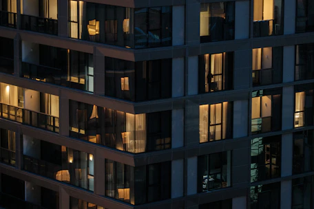 Modern building with illuminated windows at night.