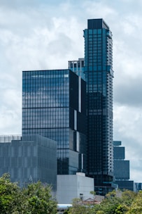 Modern skyscrapers with glass facades under cloudy sky