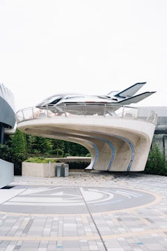 Futuristic building with a sleek vehicle on top