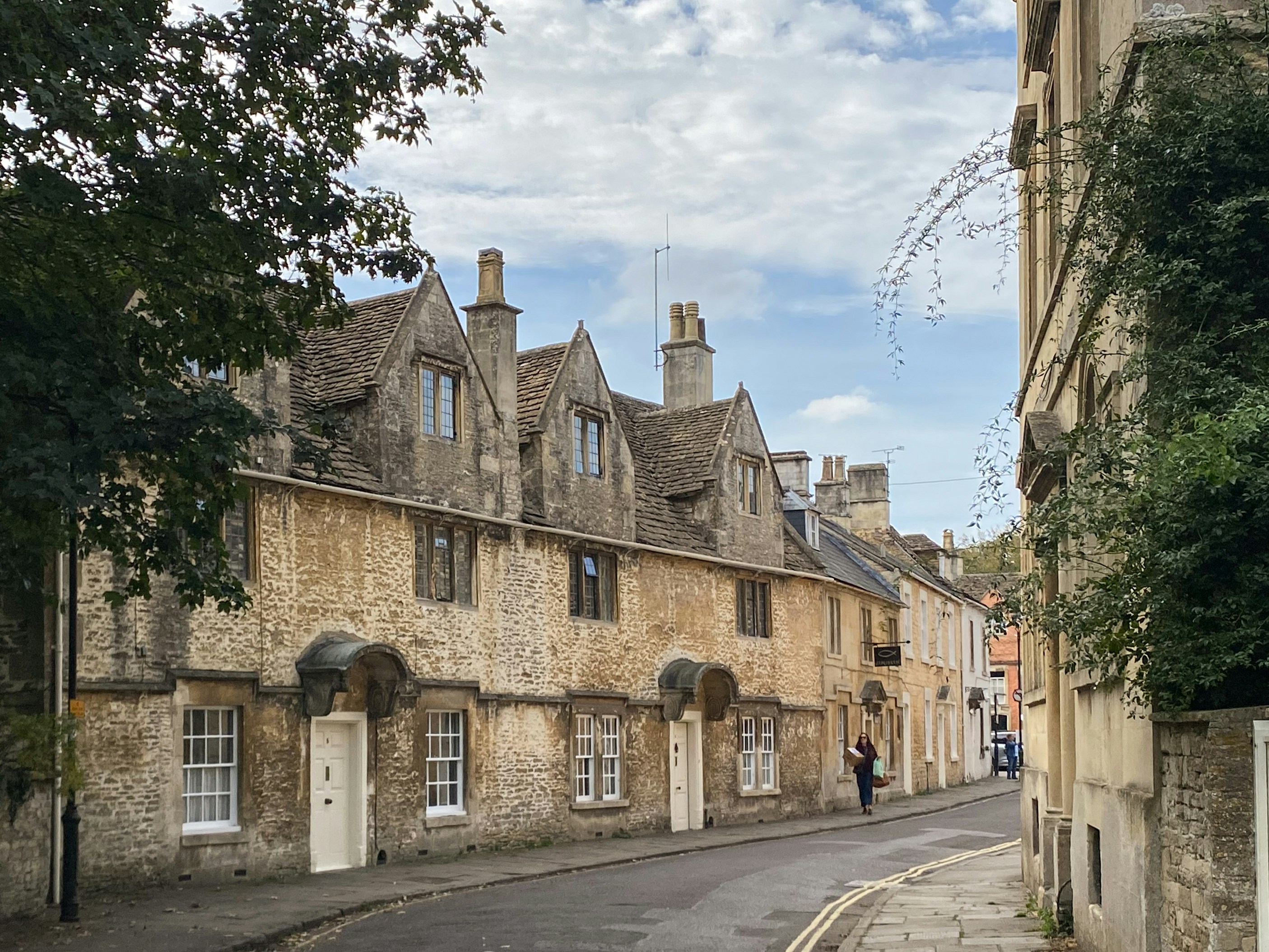 Old stone buildings line a quiet street.