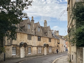 Old stone buildings line a quiet street.