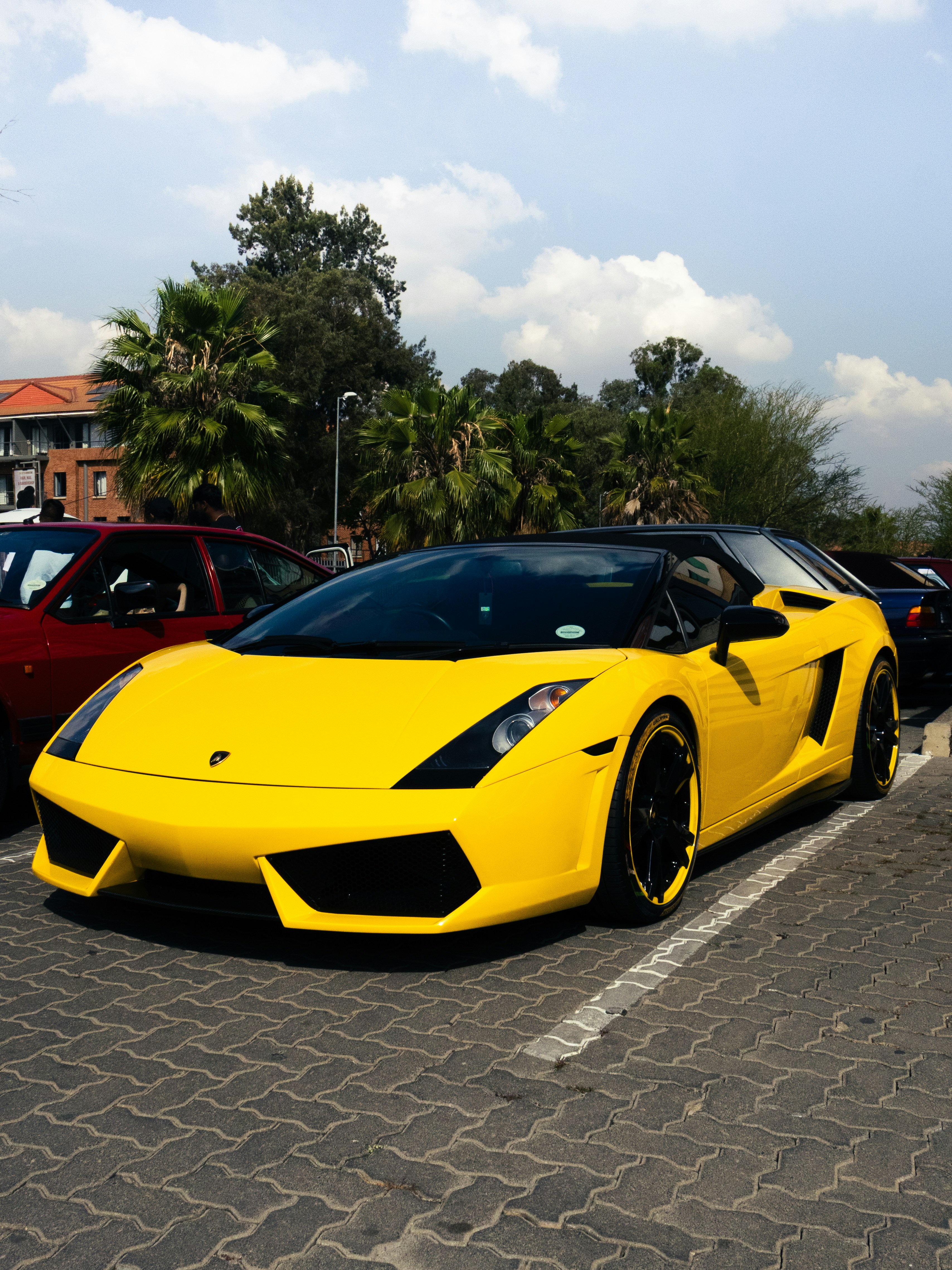 A bright yellow sports car parked outdoors.
