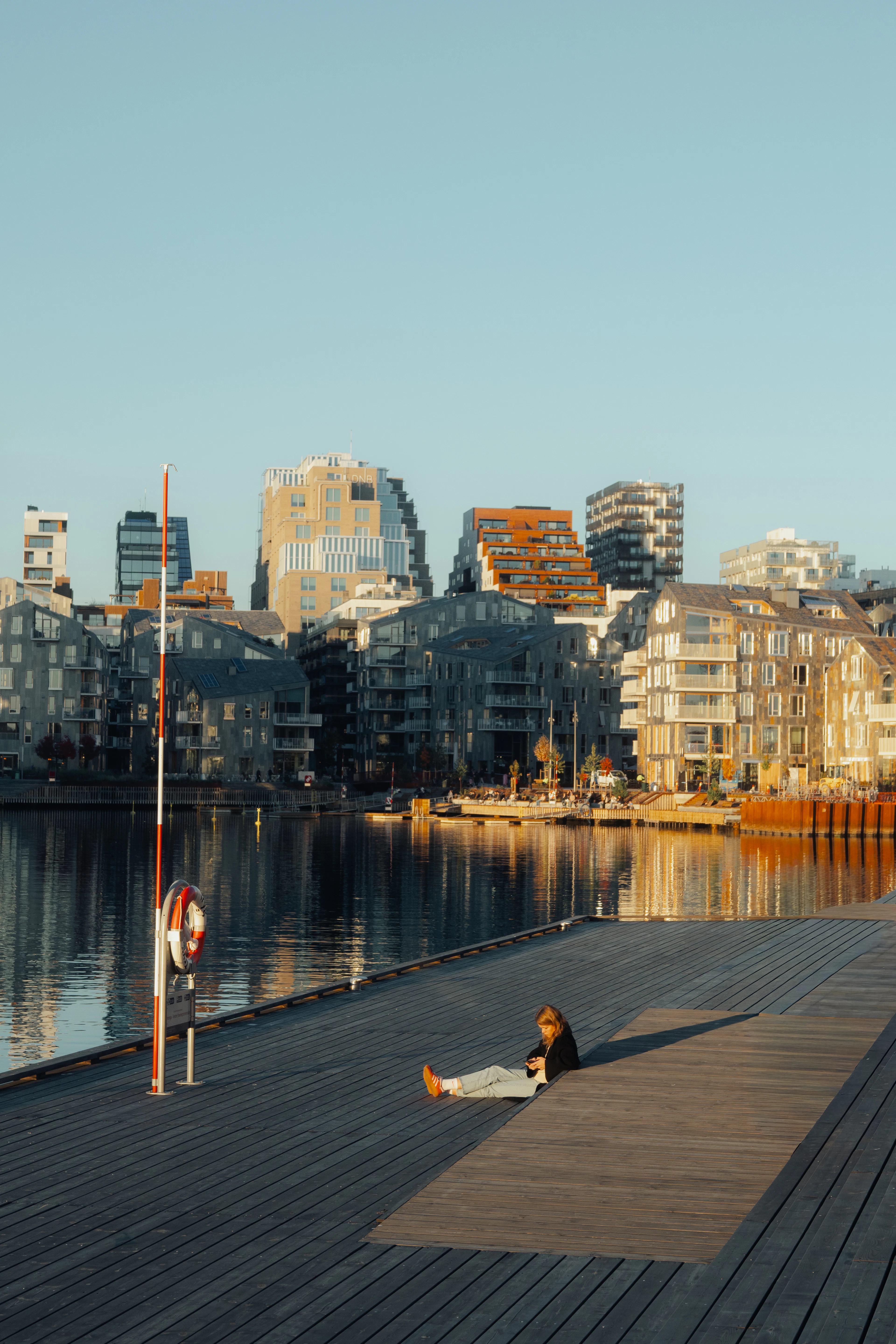 Oslo's waterfront apartments stepping down to the fjord, a boardwalk and moorings along the water