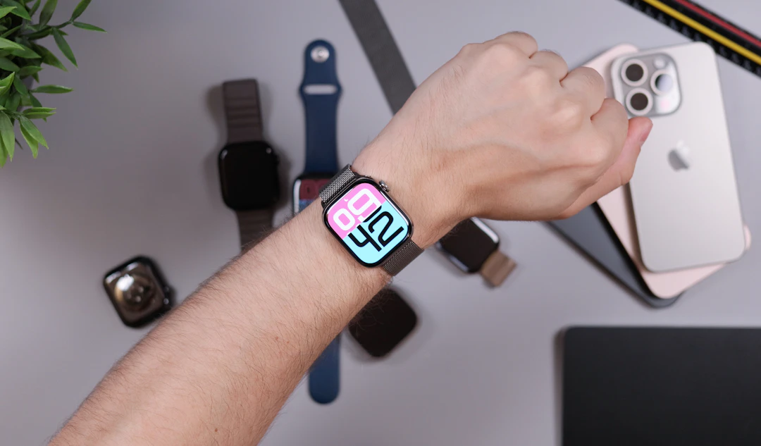 Person wearing smartwatch with iPhones and bands