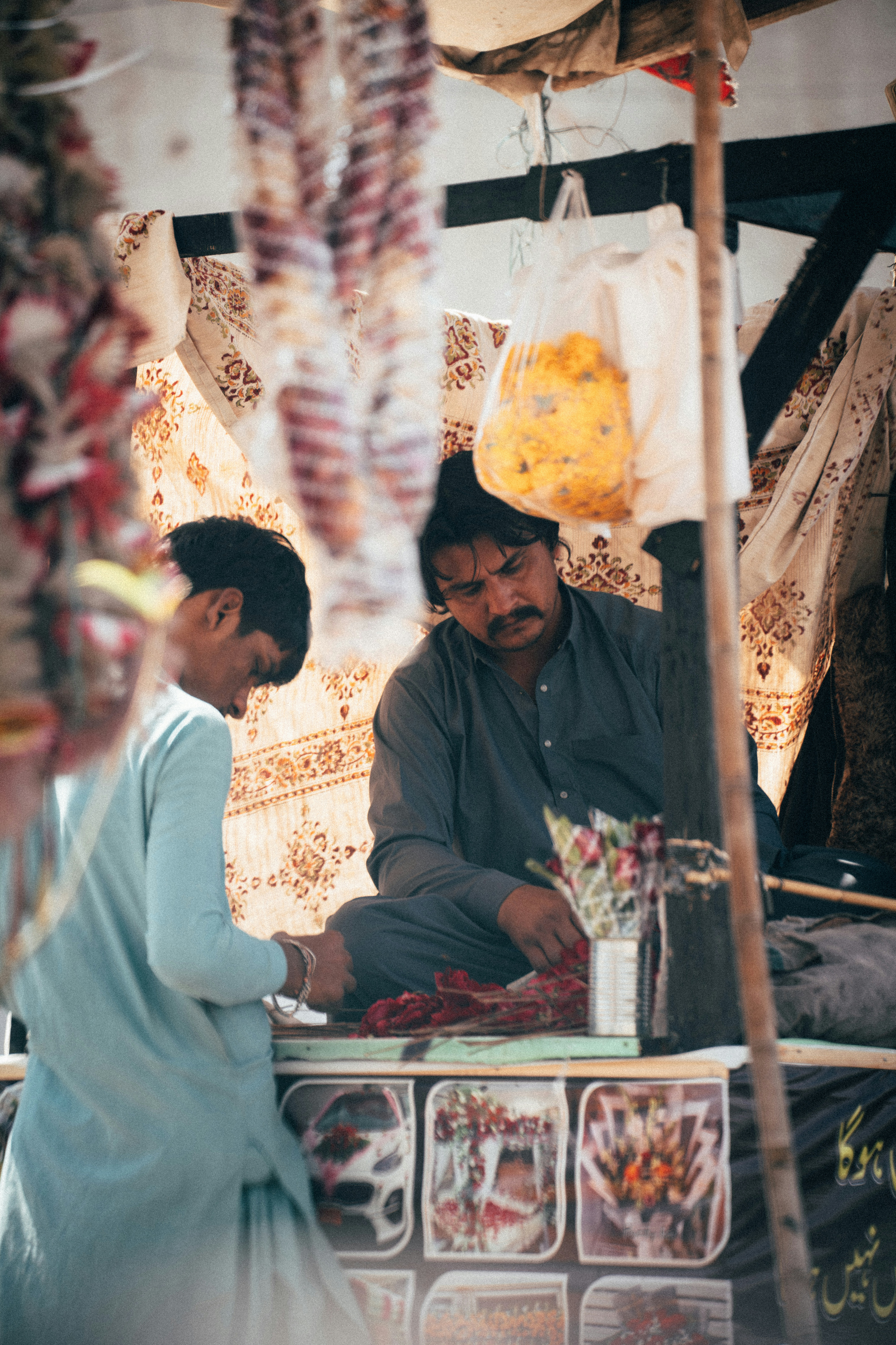 Two men working at a market stall