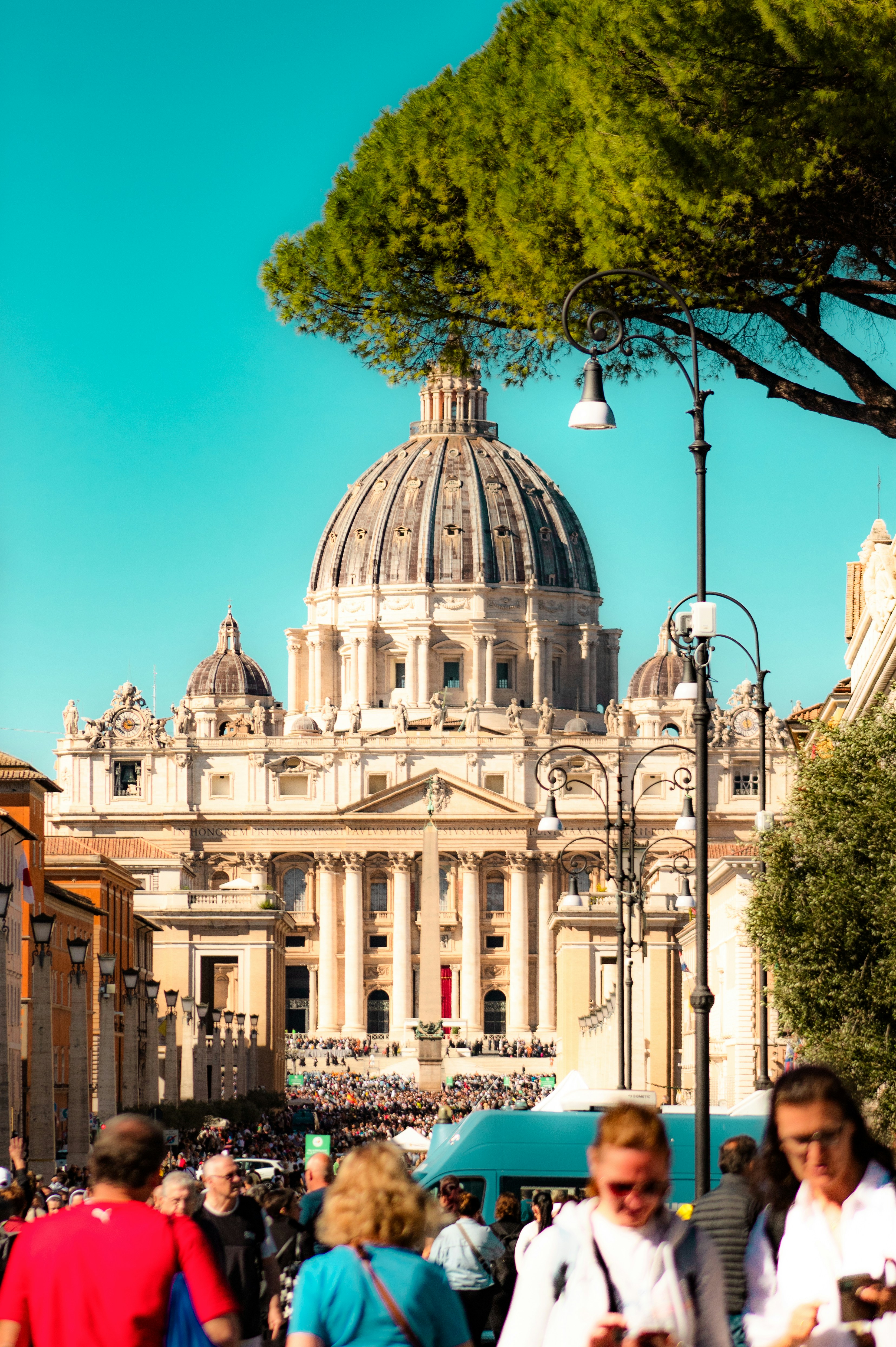 St. peter's basilica dome against a bright blue sky.