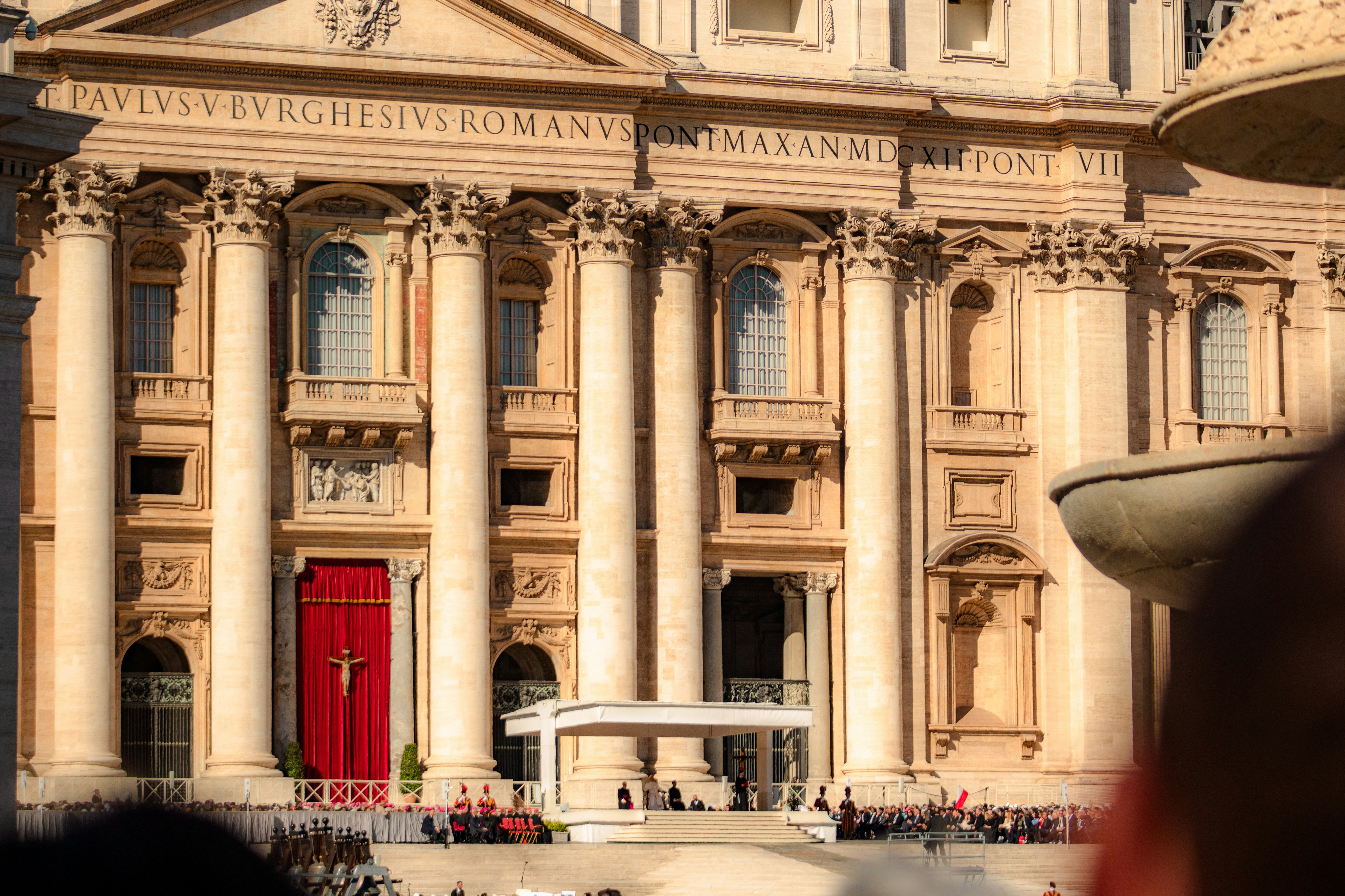 Grand facade of st. peter's basilica with red doors.