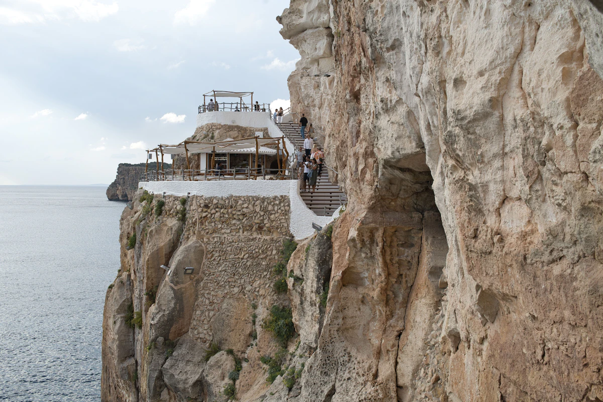 Cliffside terrace overlooking the sea at Cova d'en Xoroi, Menorca
