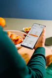 Person using phone with currency exchange rates