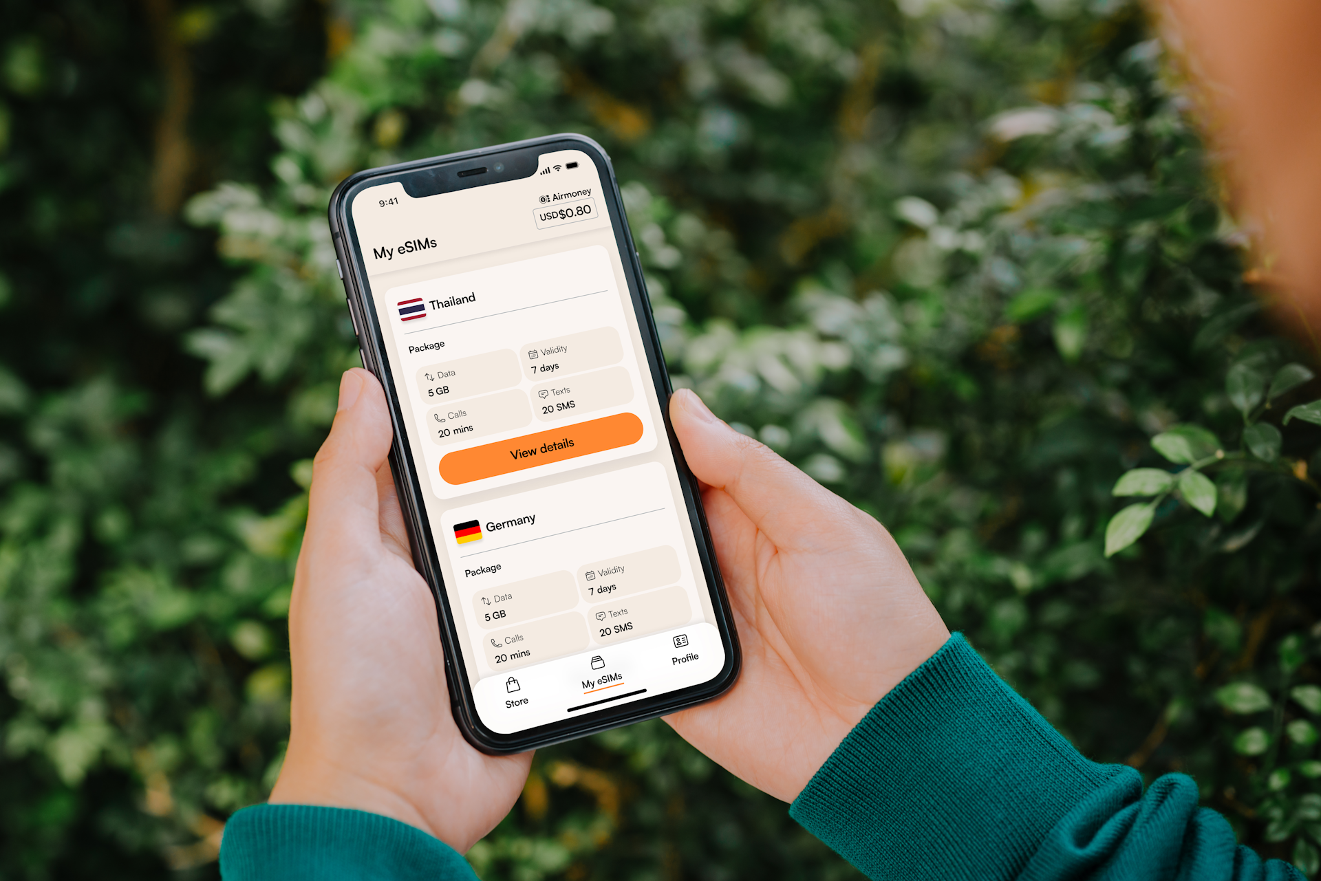 Person holding a smartphone with currency exchange app