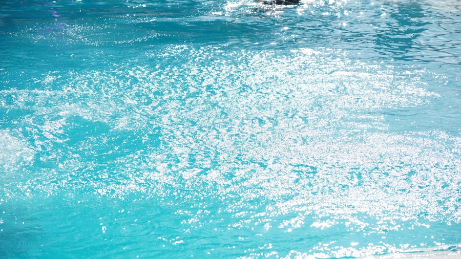 Bubbles and ripples on a bright blue pool surface in sunlight