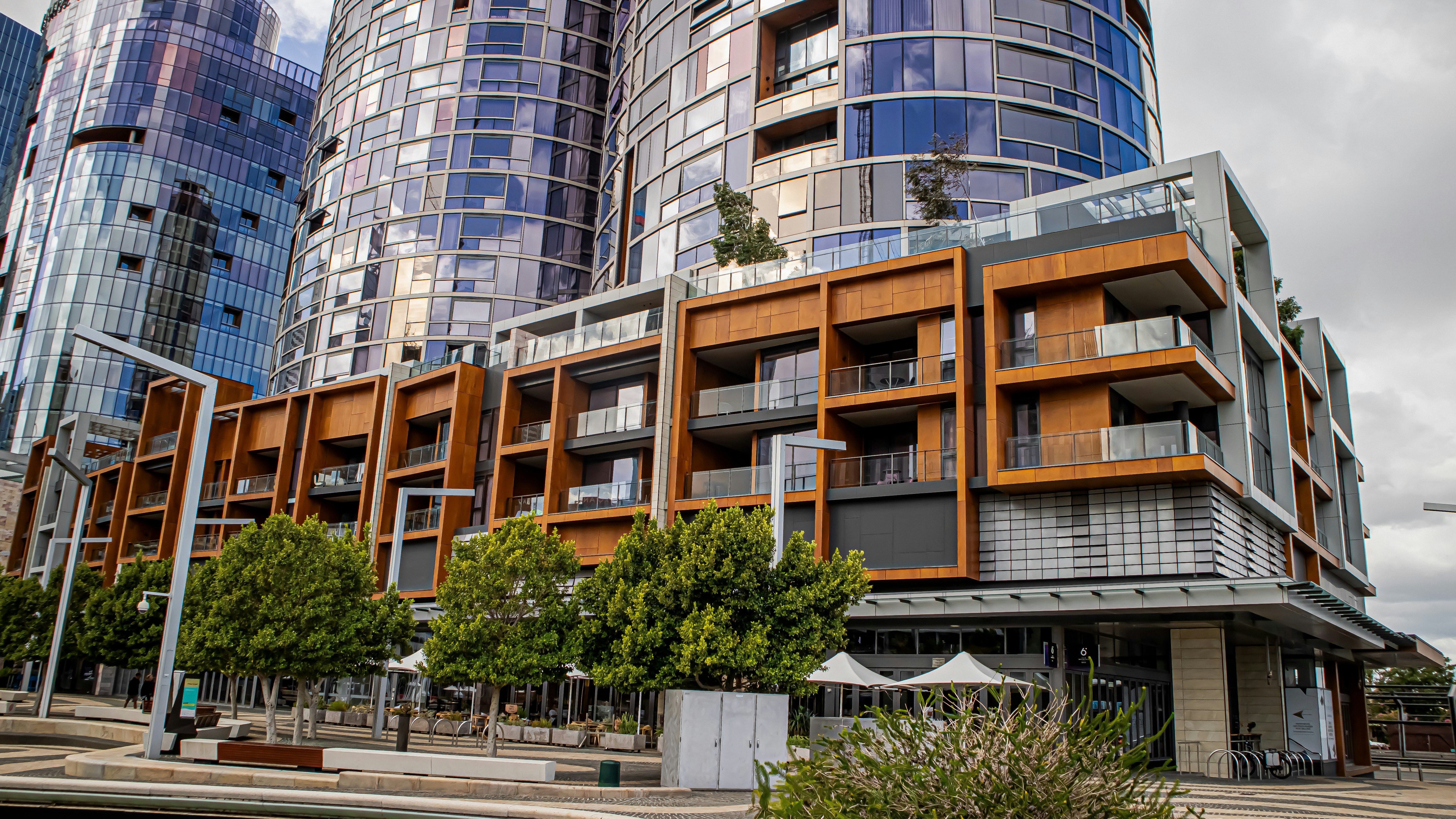 Modern apartment buildings with balconies and trees.