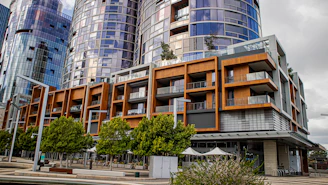 Modern apartment buildings with balconies and trees.