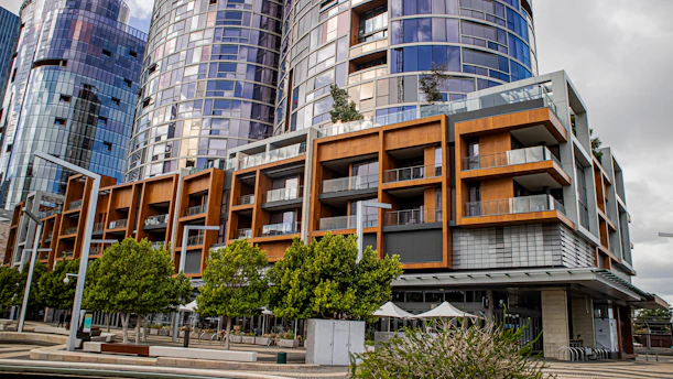 Modern apartment buildings with balconies and trees.