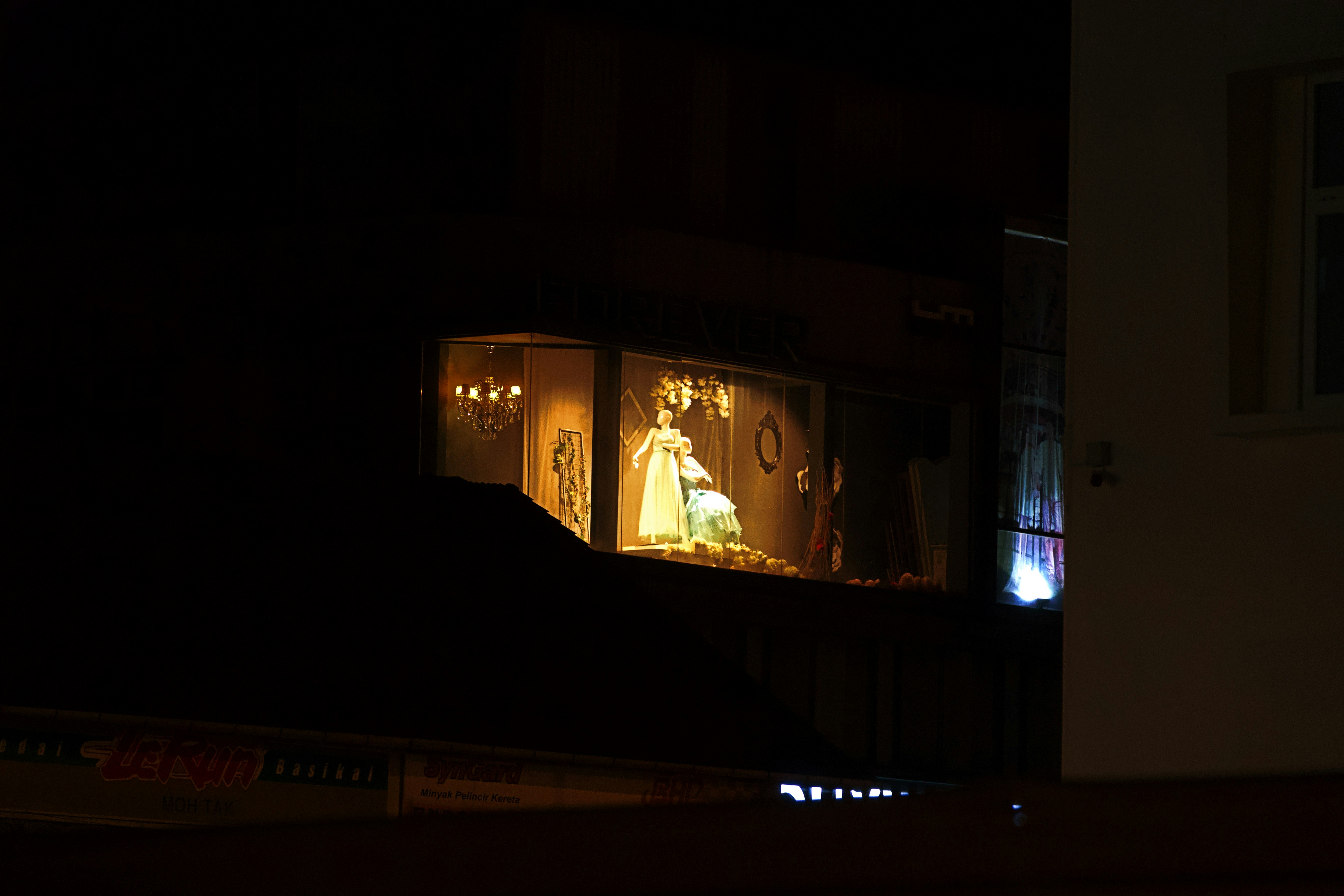 A brightly lit window display at night