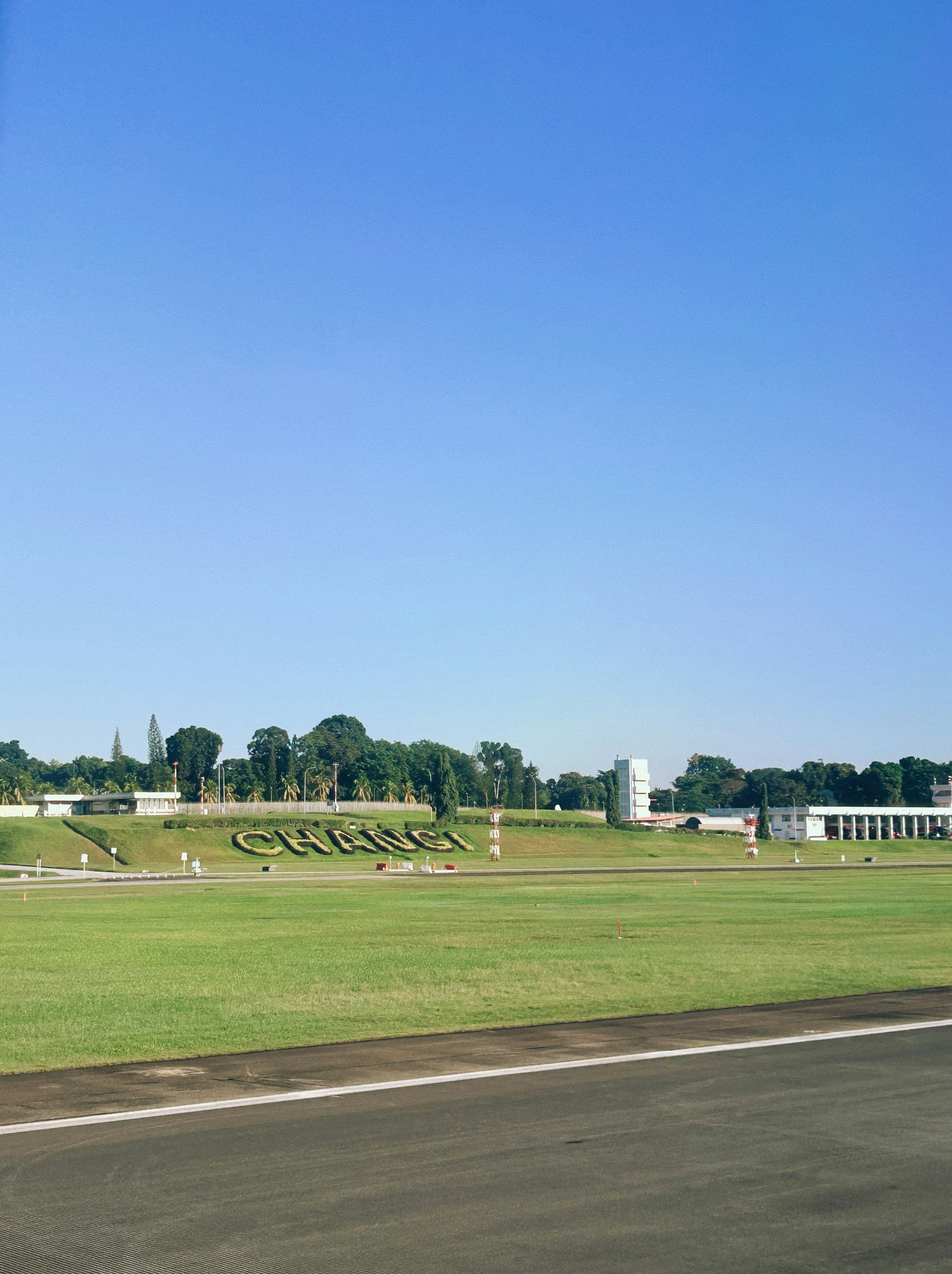 Large letters spell out "changi" on a grassy hill.