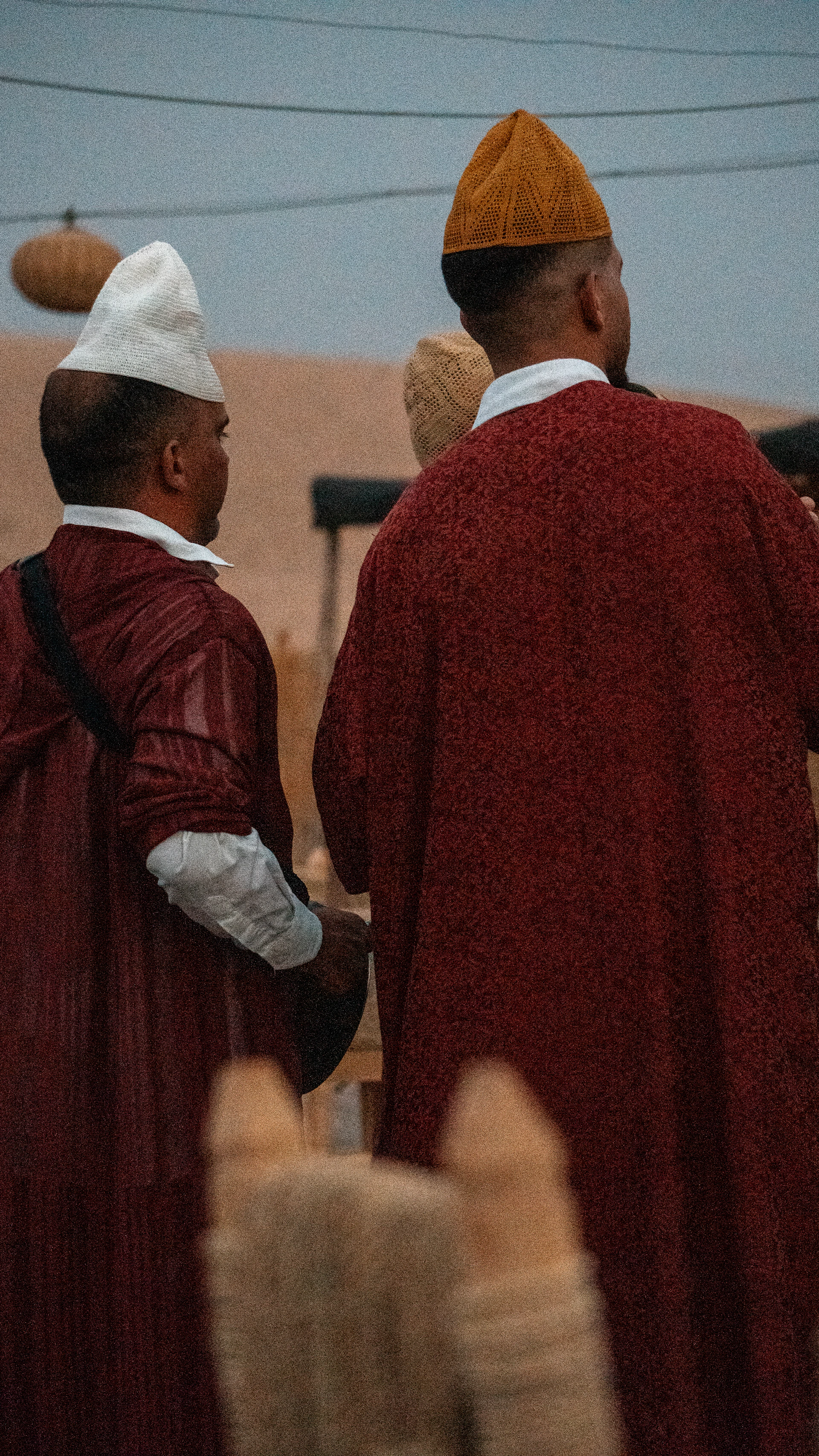 Two men in traditional moroccan clothing and hats.