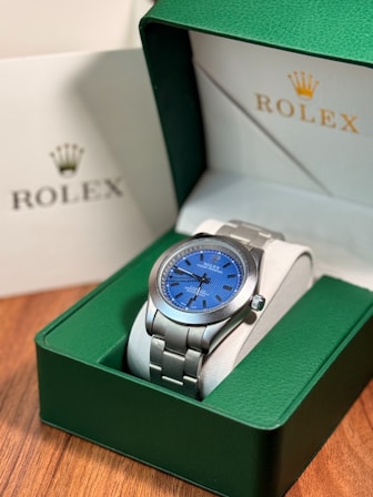 Rolex watch with blue dial in green box