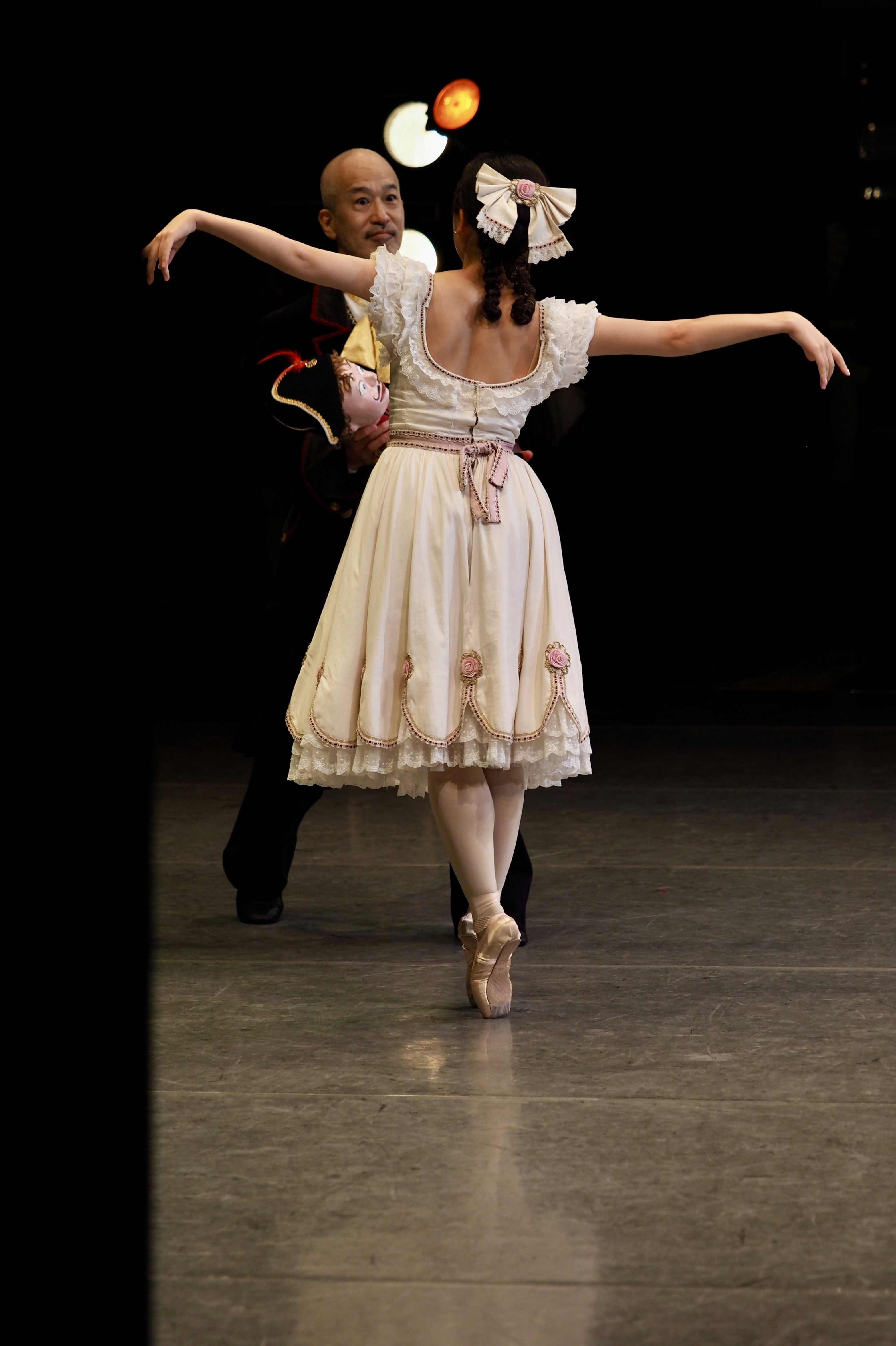 Ballerinas performing on stage with spotlights