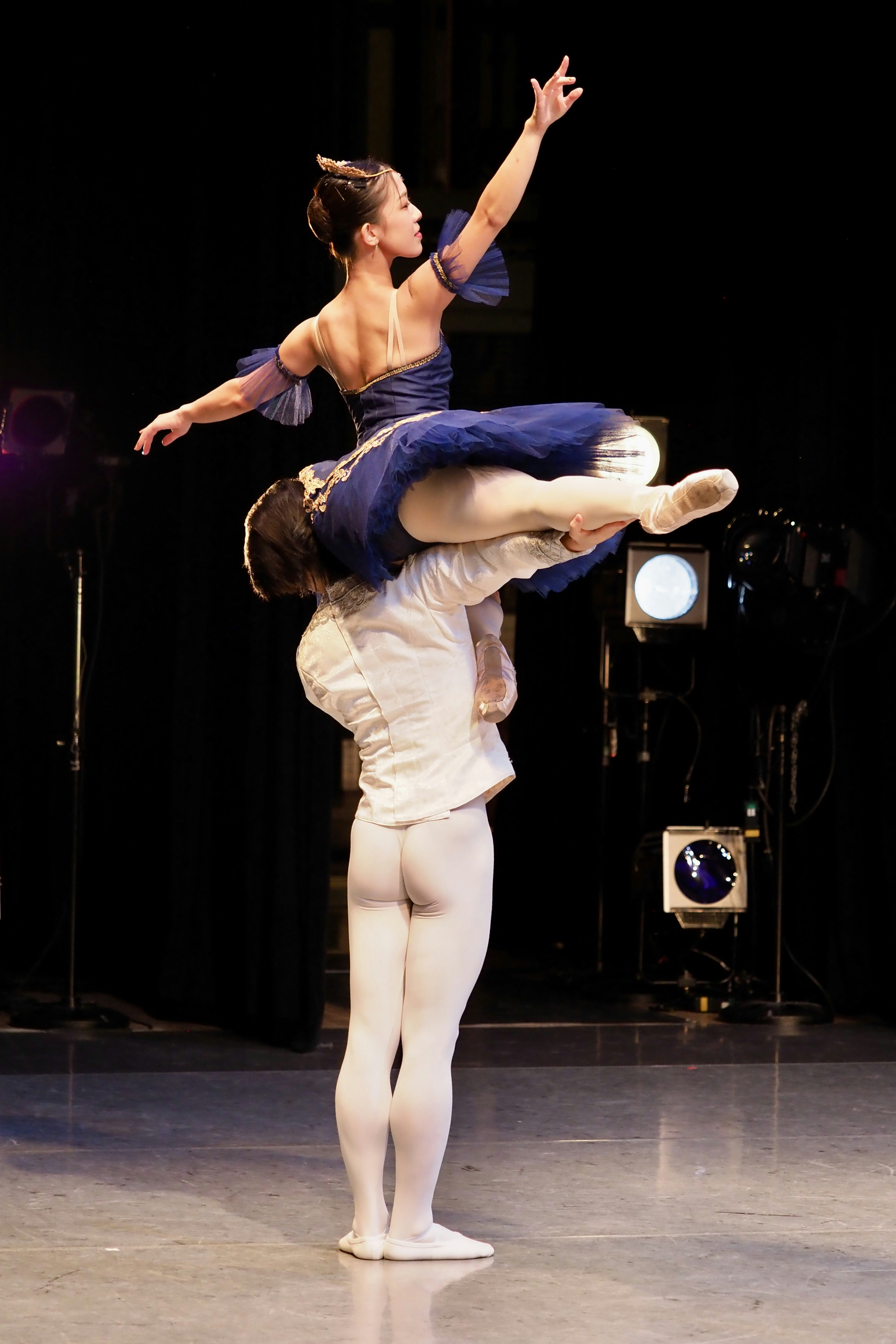 Ballet dancers perform a lift on stage