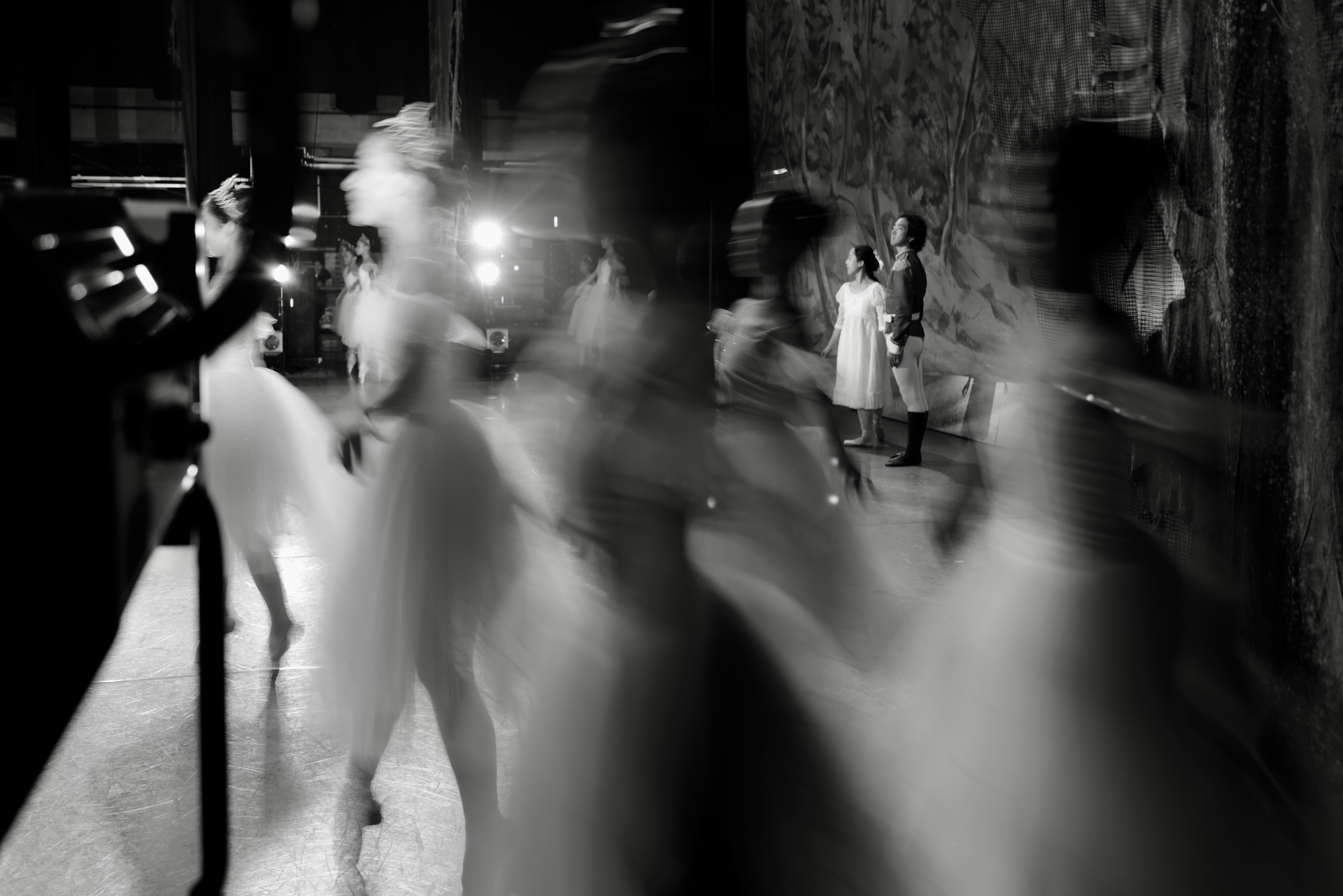 Blurred figures in a dimly lit, urban setting