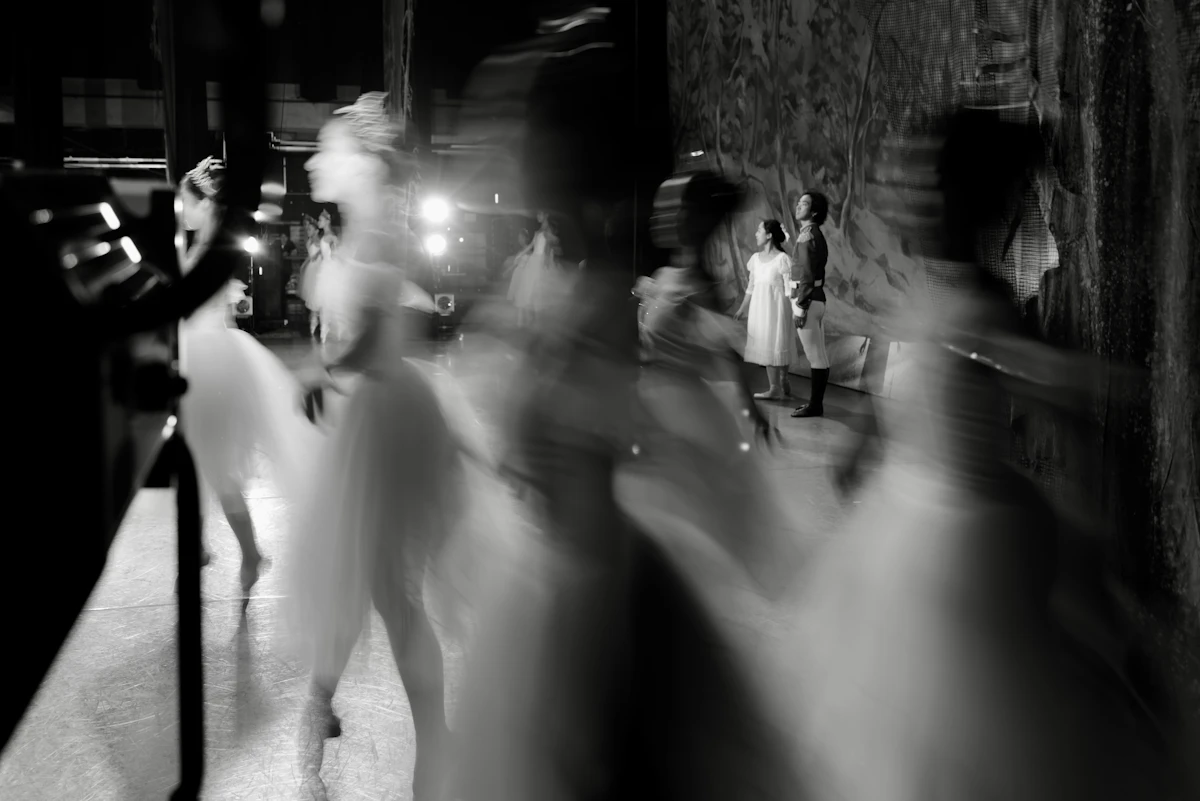 Blurred figures in a dimly lit urban setting