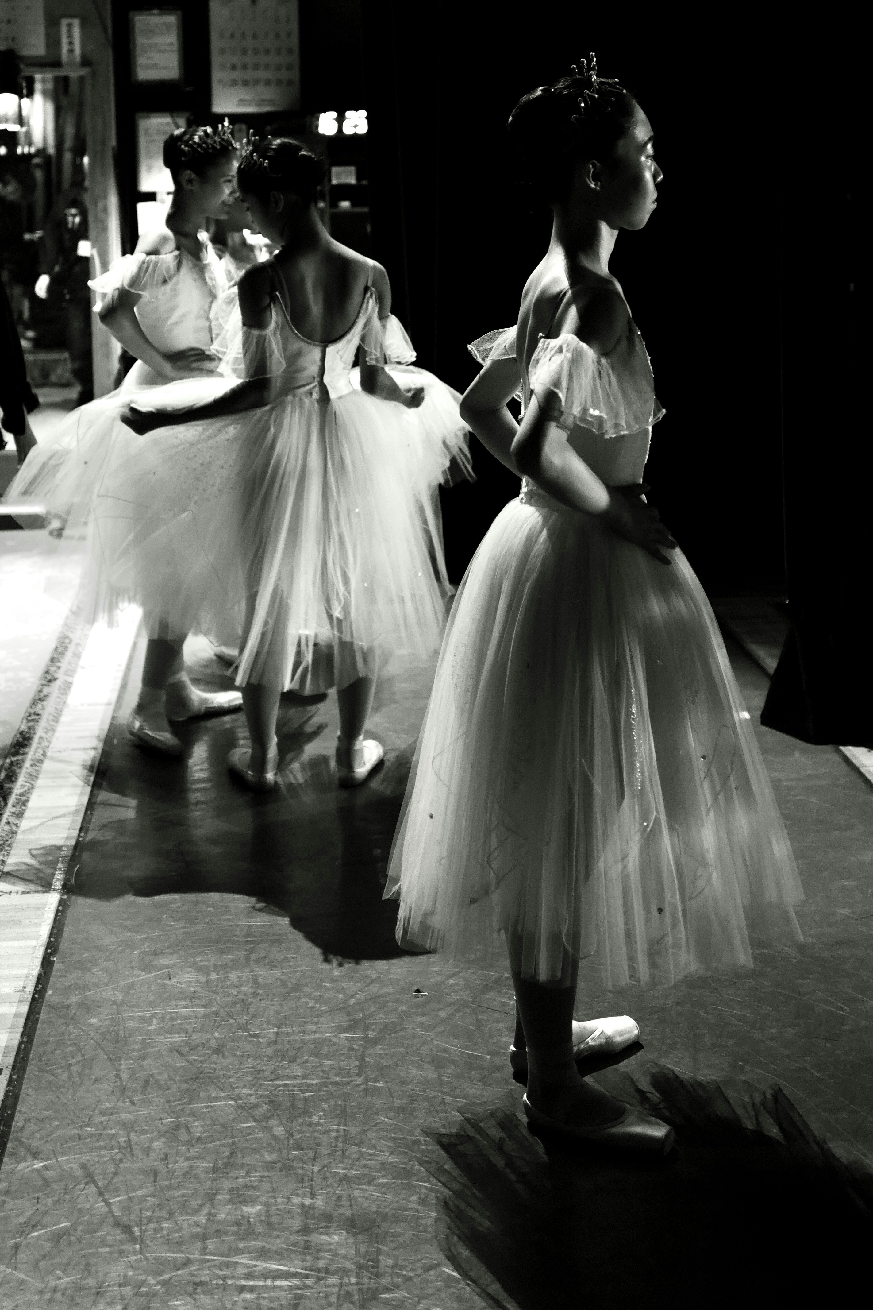 Young ballerinas in tutus backstage waiting.