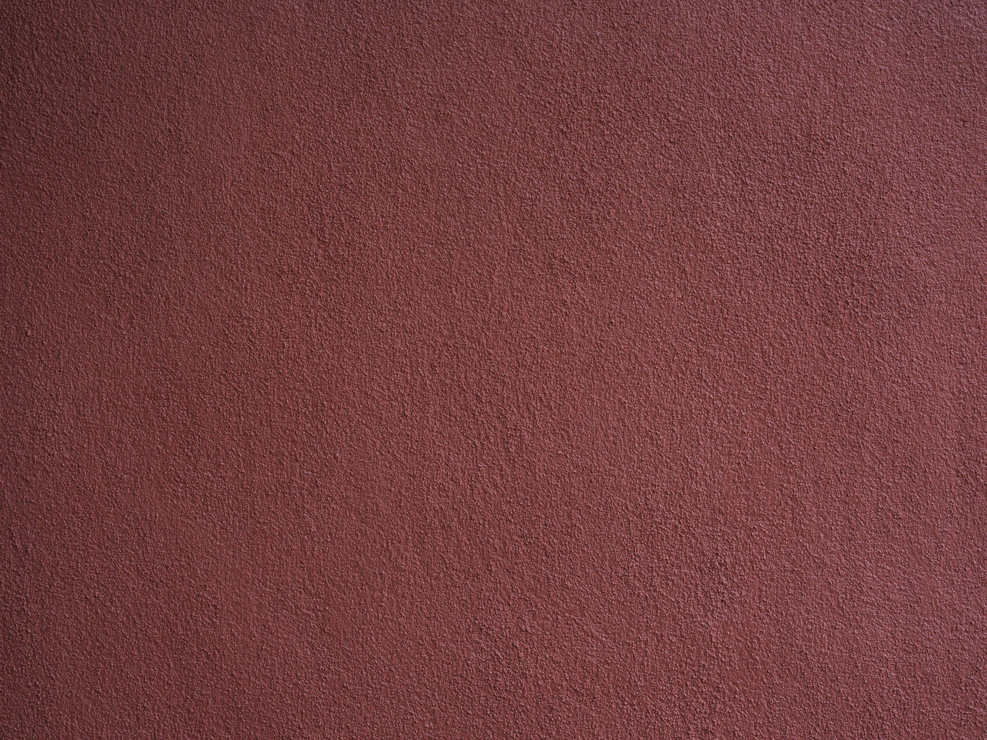 A textured reddish-brown wall surface.