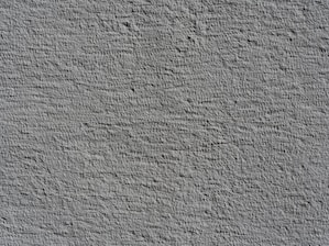 Rough textured gray wall surface with shadows