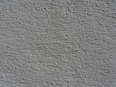 Rough textured gray wall surface with shadows