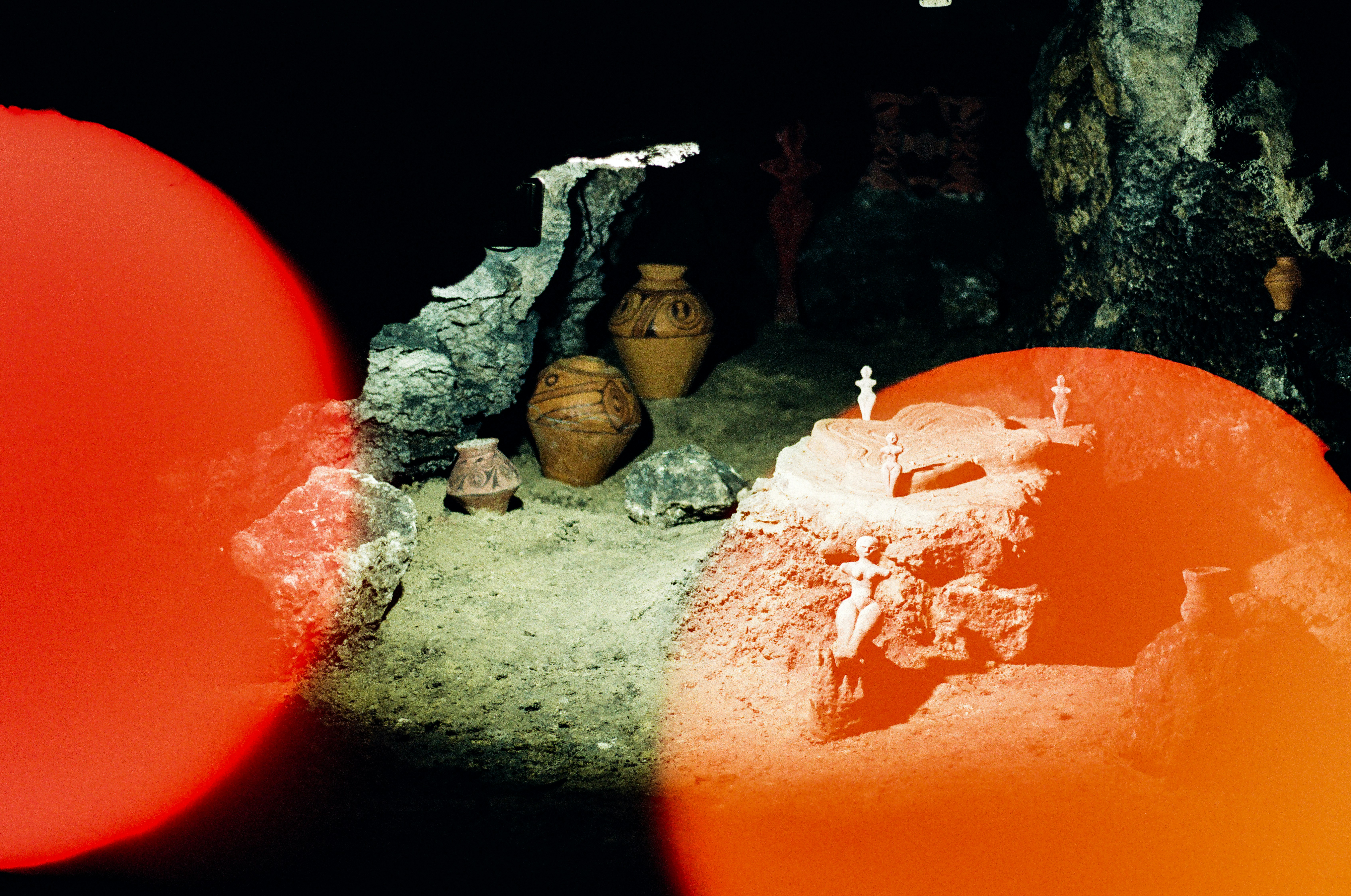 Ancient pottery displayed in a cave exhibit.