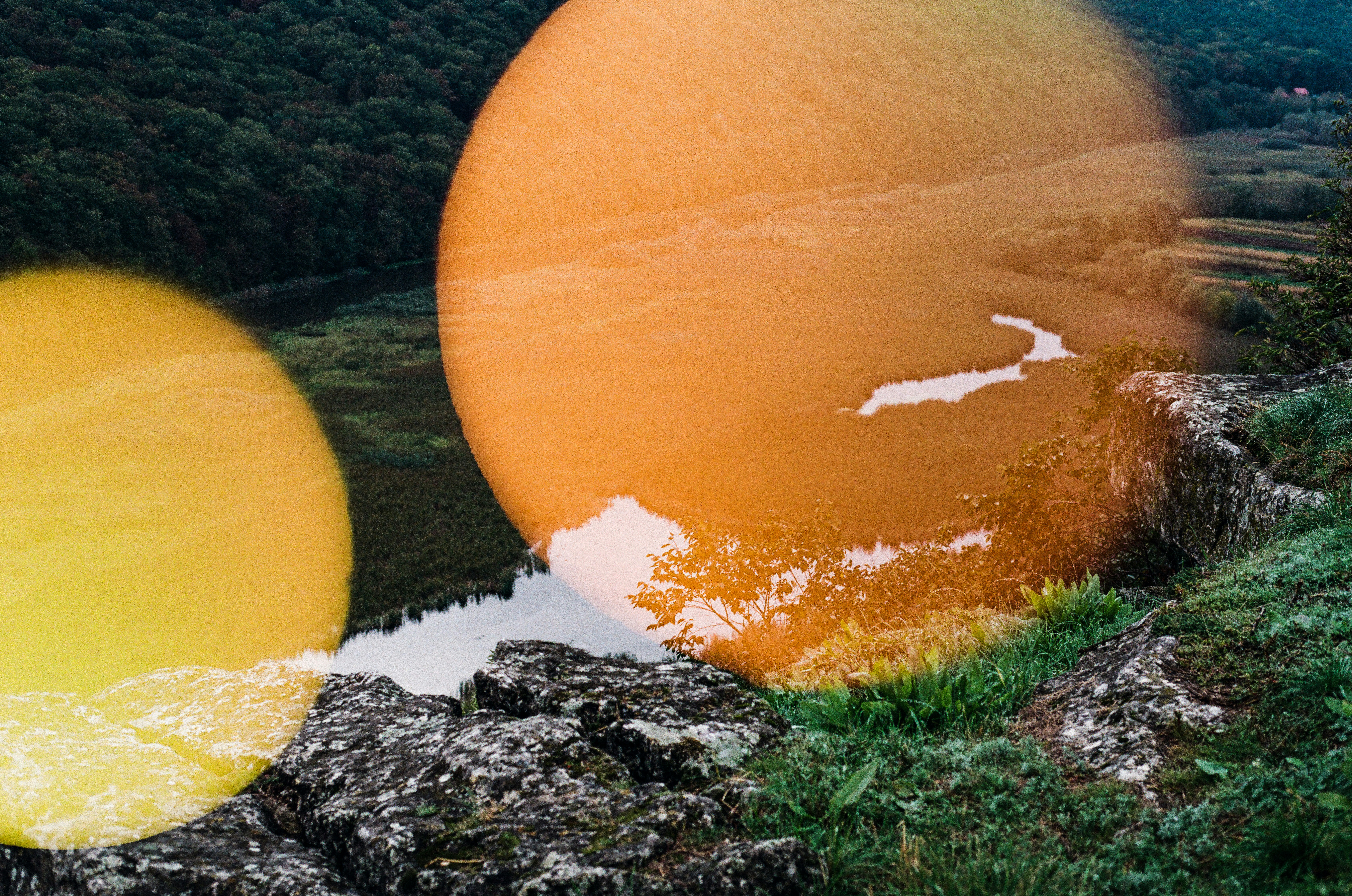 Double exposure of sun and rocky landscape