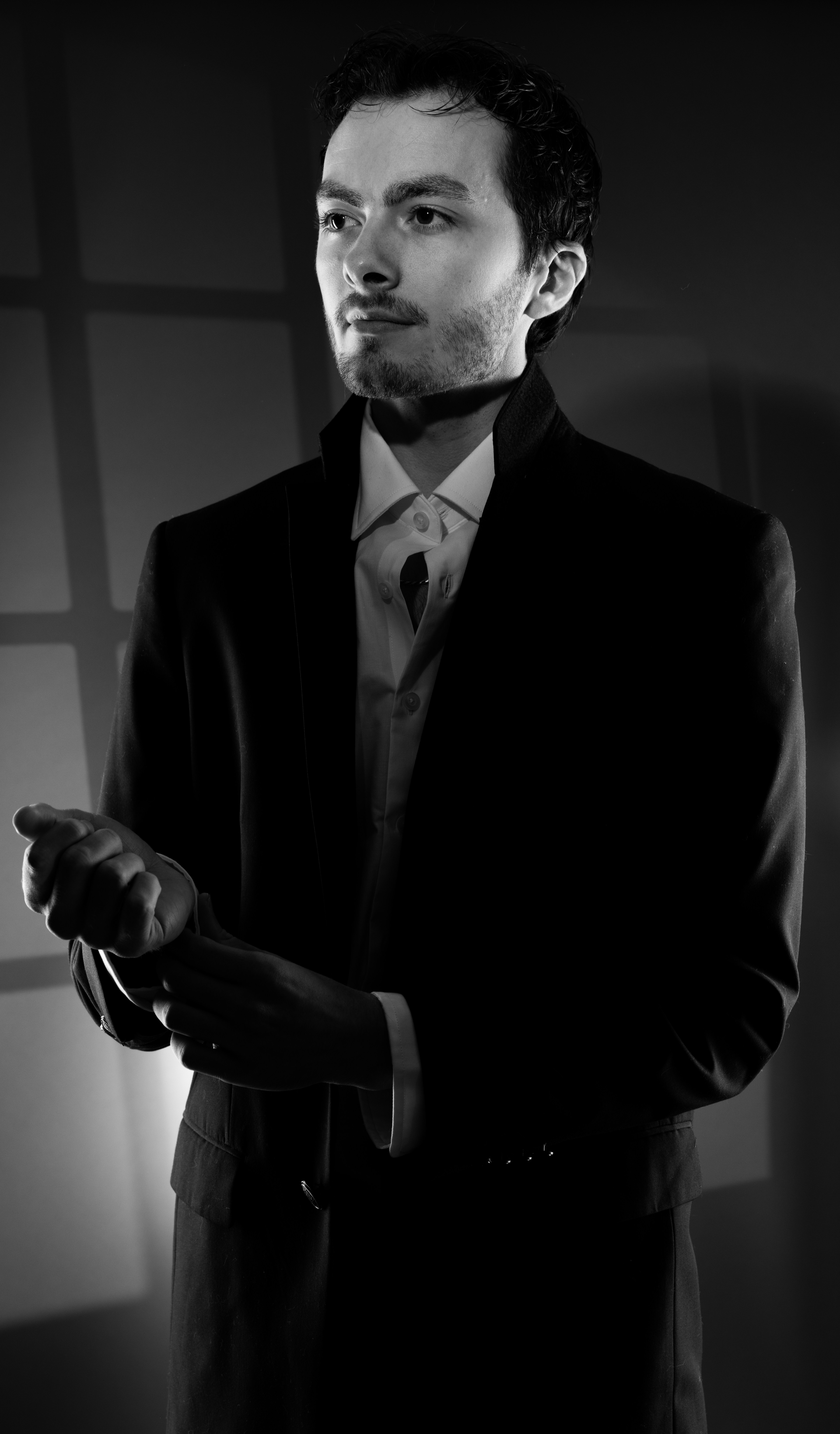 Mann im Anzug, der seine Manschettenknöpfe zurechtrückt