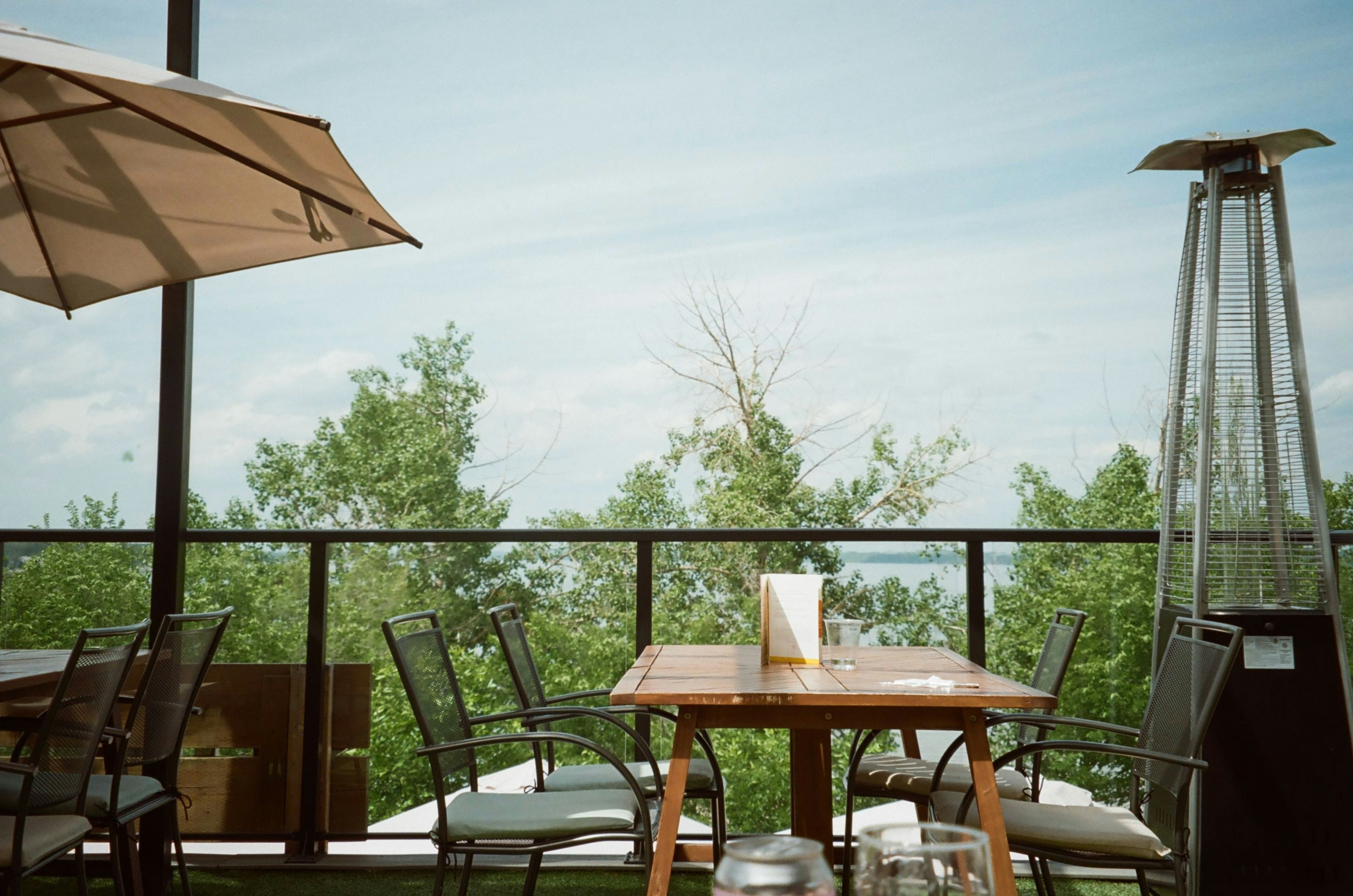Outdoor patio seating with a view of trees and trees.