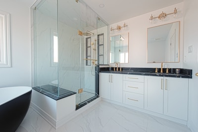Modern bathroom with a freestanding tub and glass shower.