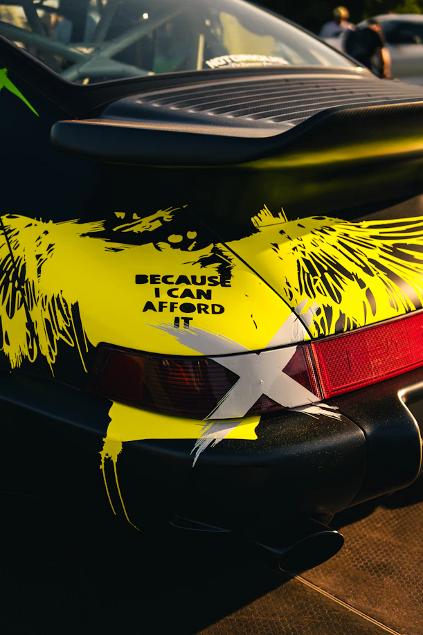 Black car with yellow abstract design and text.