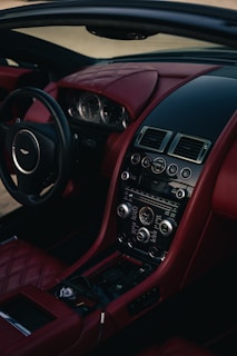 Luxury car interior with red leather seats.