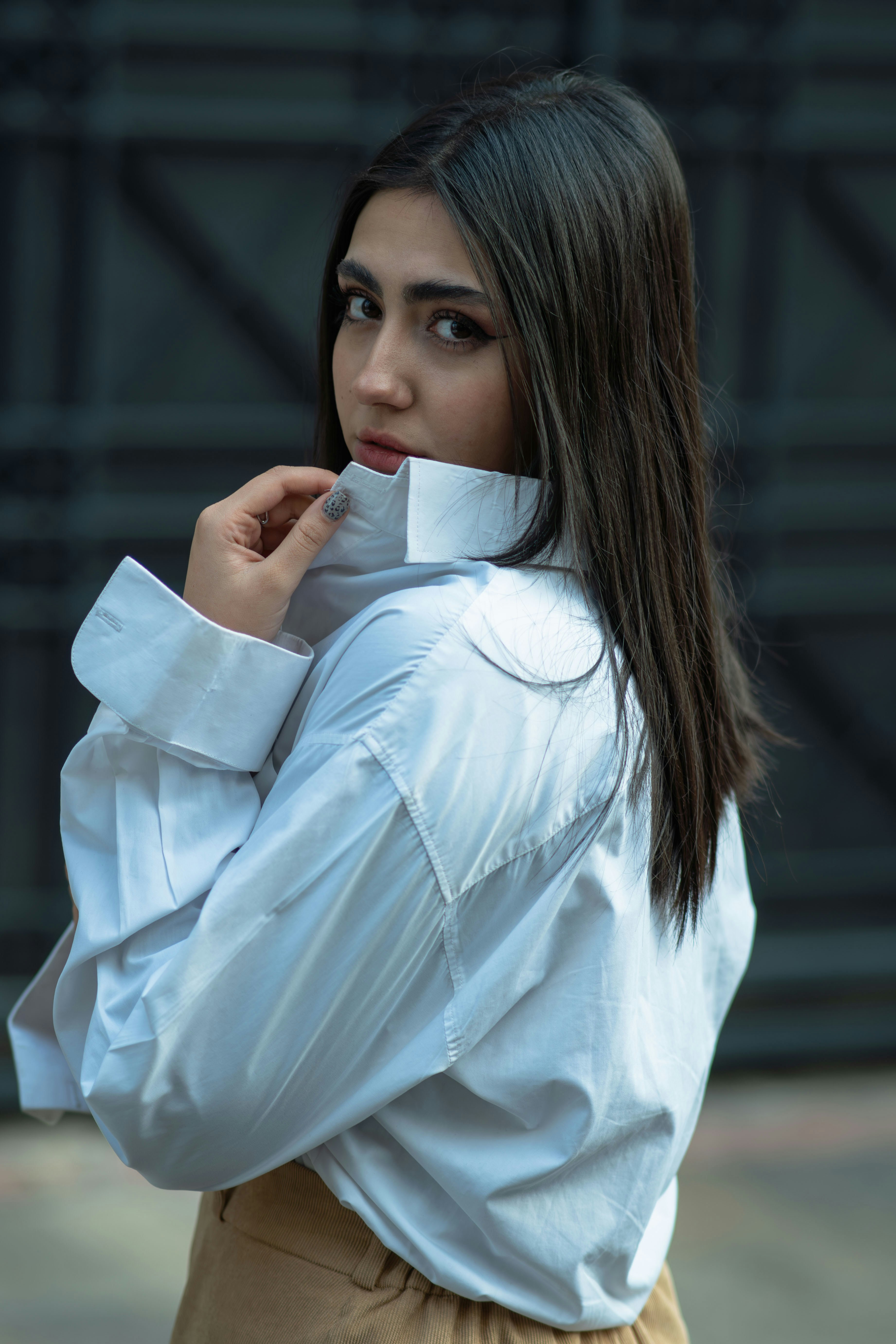 Woman in white shirt looking over shoulder