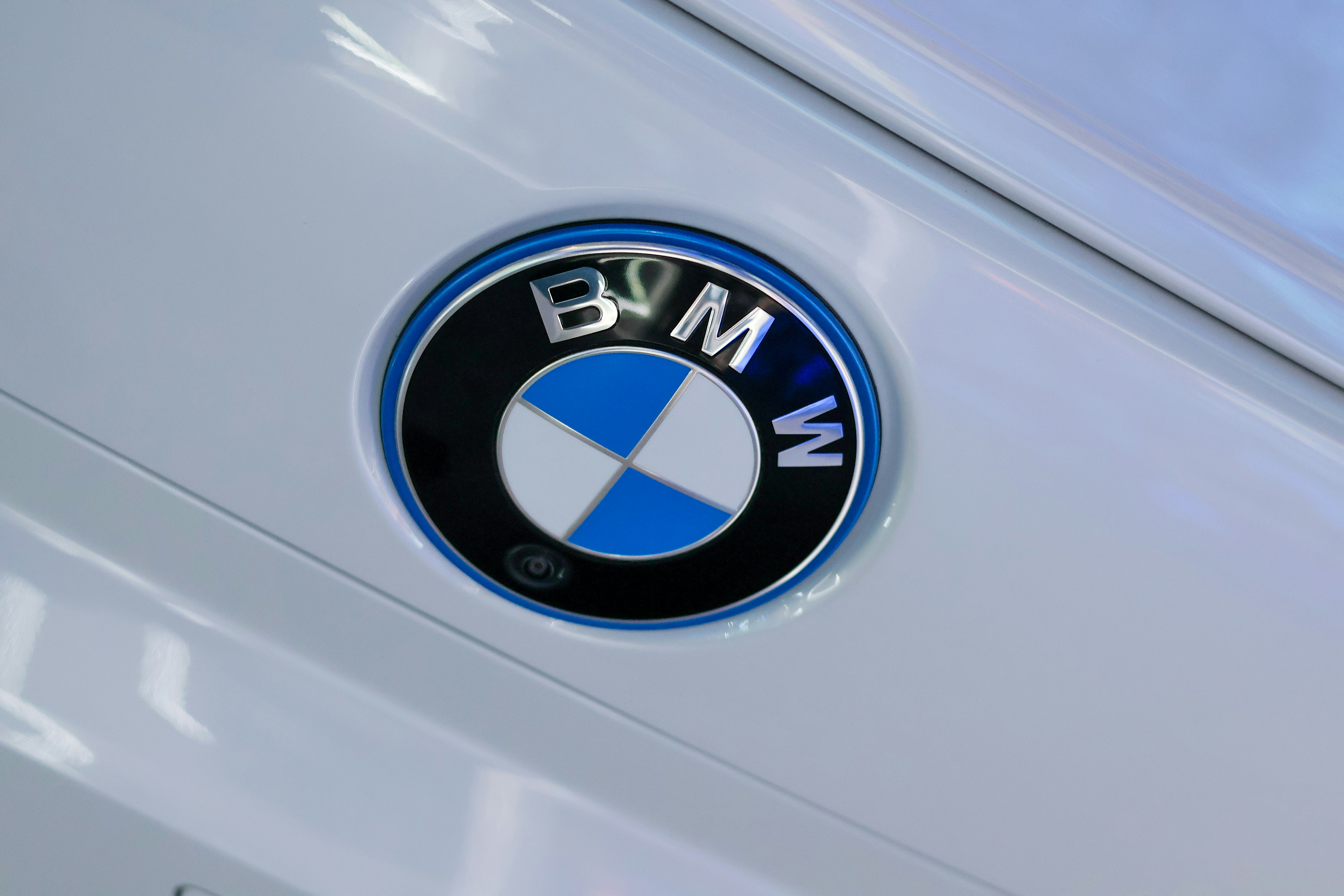 Close-up of a white BMW car emblem