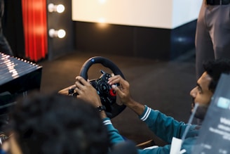 Man playing racing simulator with steering wheel