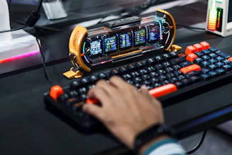 Gamer typing on a futuristic keyboard with multiple screens.