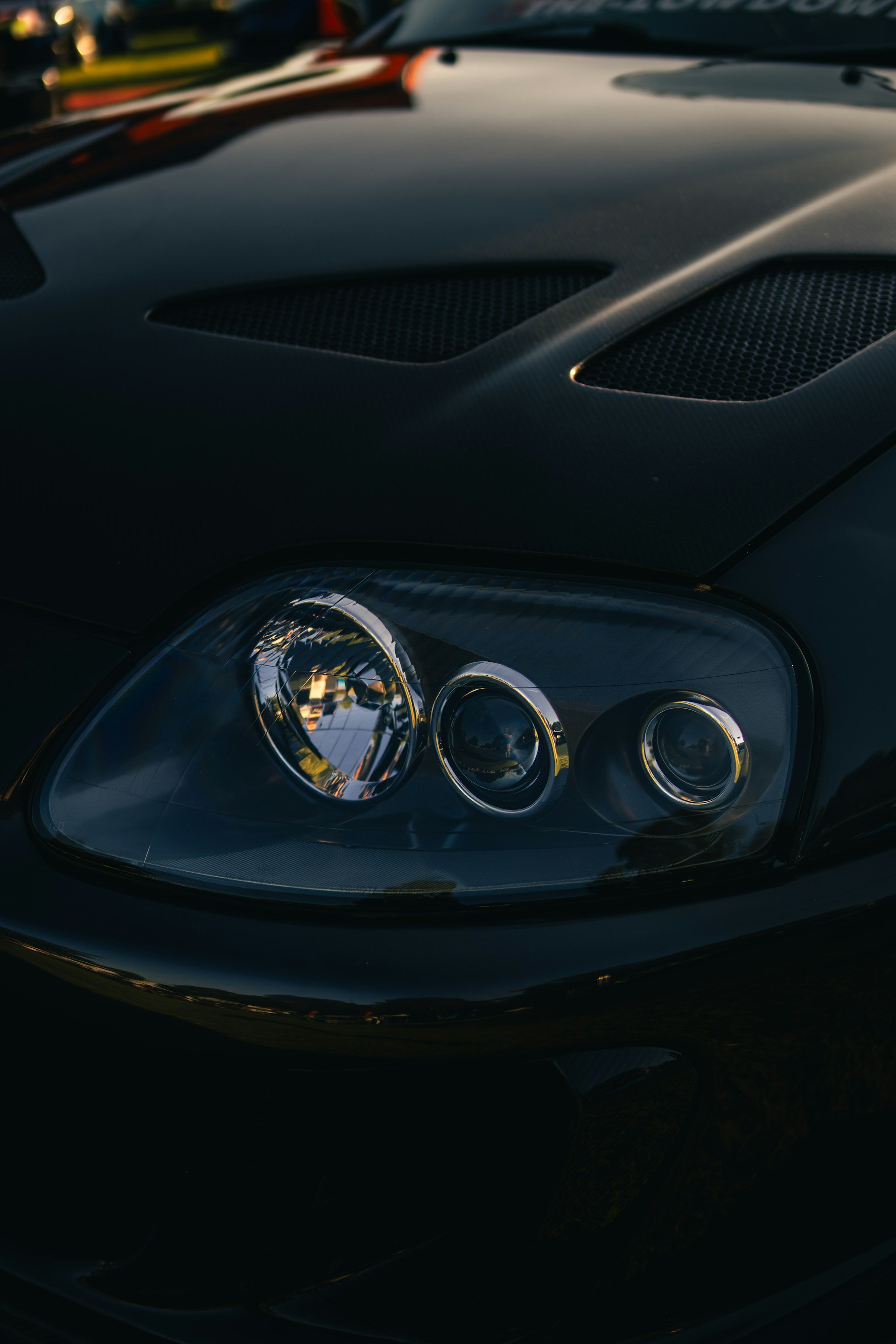 Close-up of a black car's headlight