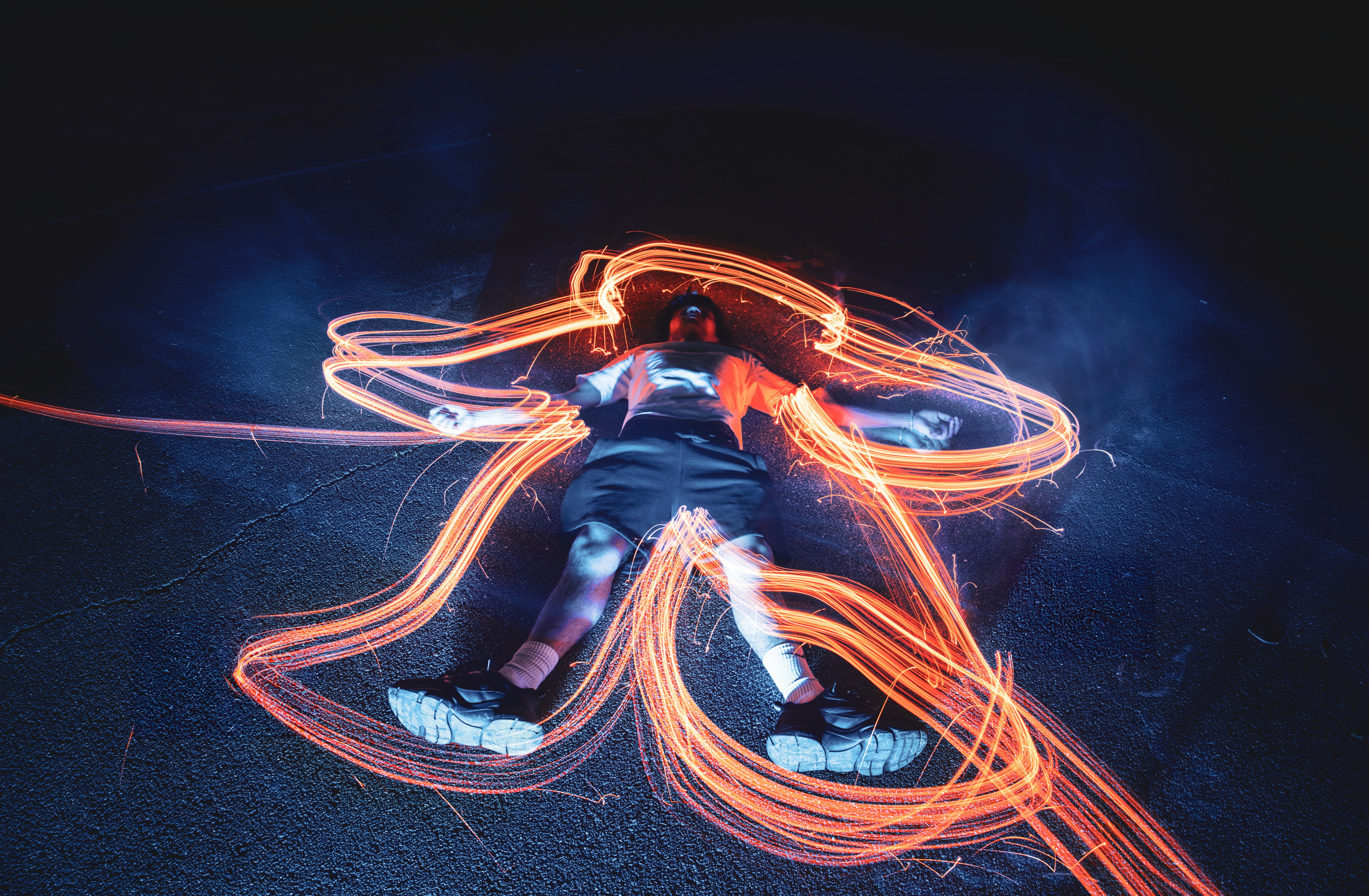 A person riding an electric kickscooter through a city park.