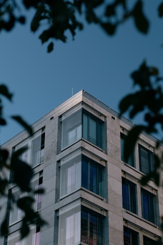 Modern building with reflective windows against blue sky