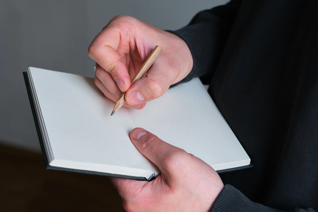 A notebook and pen, representing a written complaint to a state agency