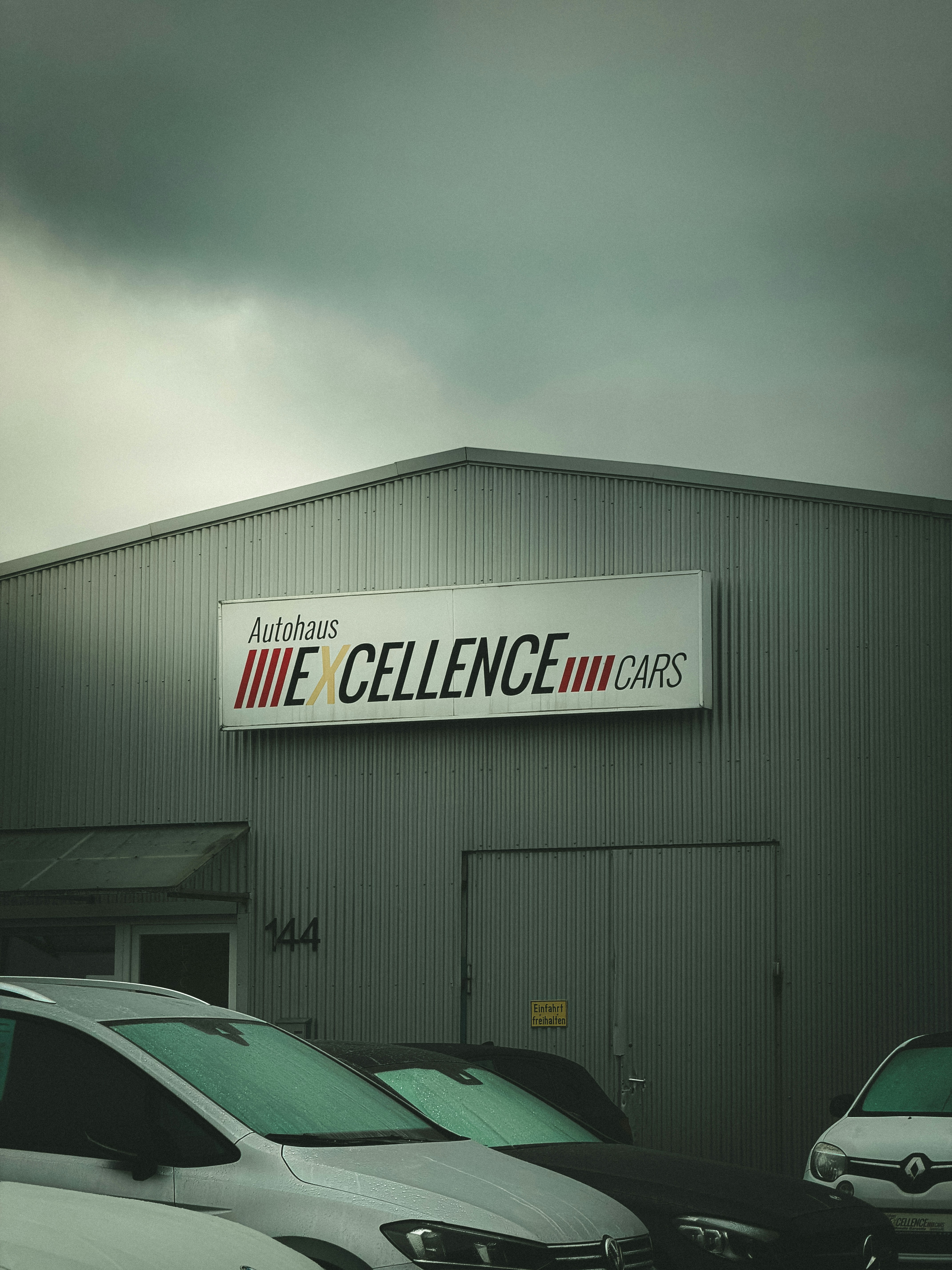 Autohaus excellence cars building with cars parked outside