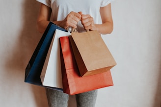 Person holding colorful shopping bags