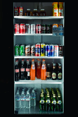 Full refrigerator stocked with assorted beverages.